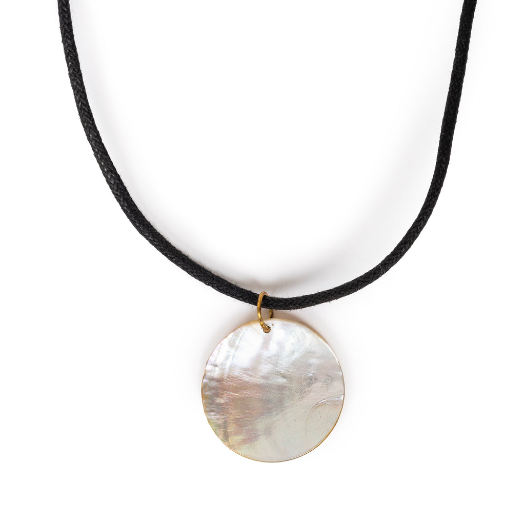 Mother of pearl round pendant necklace hanging, on a solid white background.