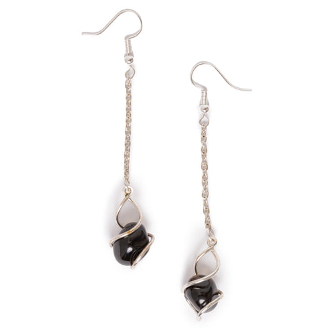 Chain dangle earrings with apache tear enclosed in bottom metal casing. Image on solid white background.