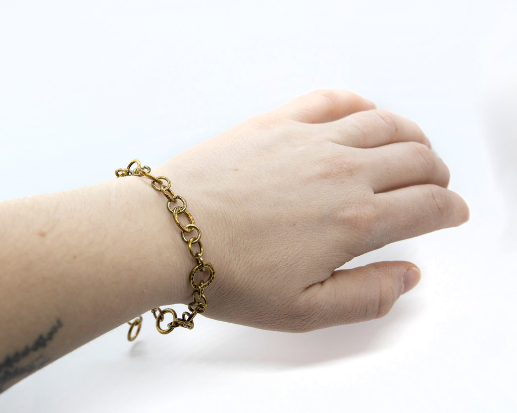 Hand model wearing autumn bracelet on wrist, showing size of chain.