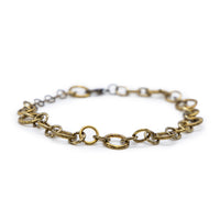 Front view of antiqued bronze bracelet sitting on table