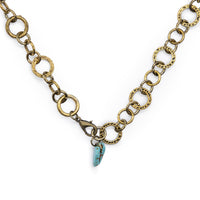 Antiqued bronze lariat style necklace open to full length, with turquoise stone hanging in middle by clasp.