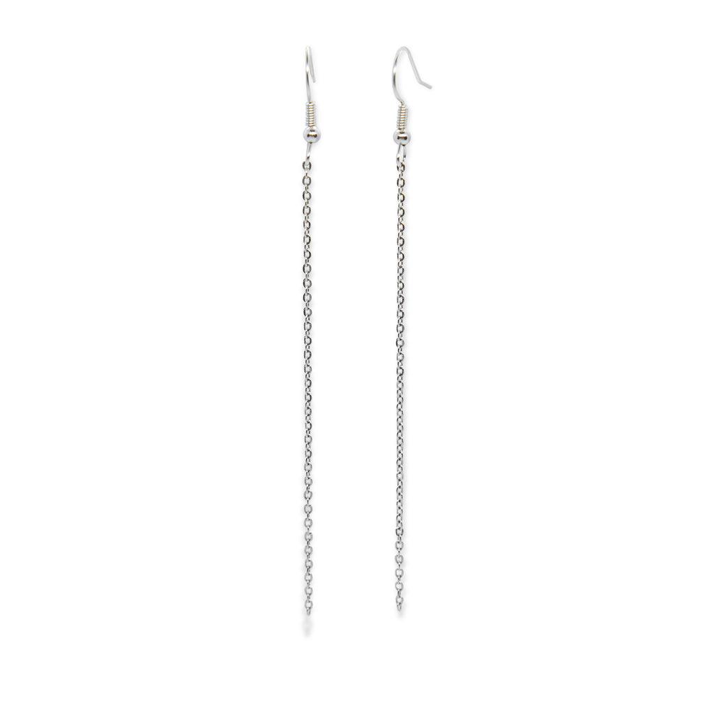 Silver tone chain earrings dangling on earring hook.