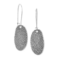 Silver tone textured dangling earrings on solid white background
