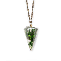 Clear resin pointed pendant filled with moss, hanging on a bronze chain