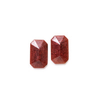 Burgundy glittery earrings both facing, on solid white background.