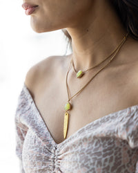 Model showing necklace detail and how it hangs on the neckline.