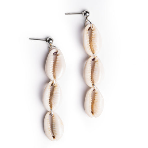 Shell earrings lay on solid white background. Each earring is 3 shells connected end to end, with a silver tone post at the top.