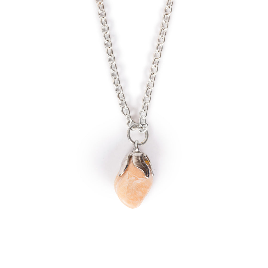 Smaller tumbled pink tone sodalite, hanging on imitation silver bail and chain. Image is on a solid white background.