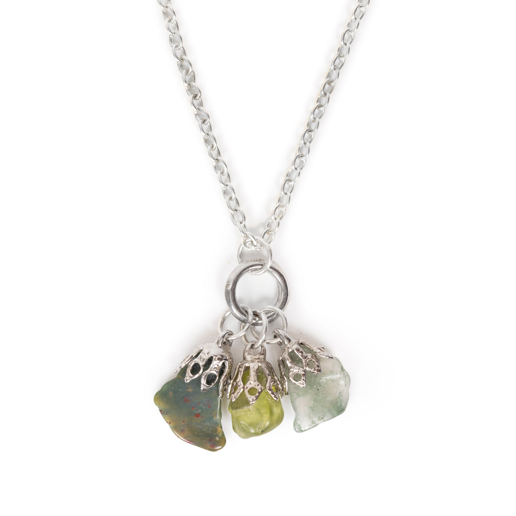 Three gemstone chips hanging together - Two jasper and peridot. Necklace is on silver chain, and image has a solid white background.