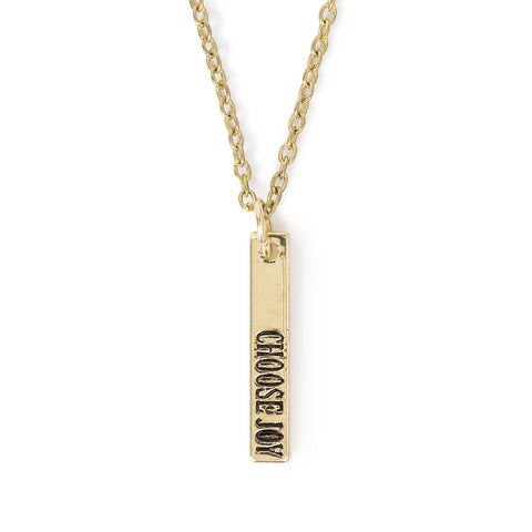 Choose Joy metal charm necklace, hanging on solid white background.