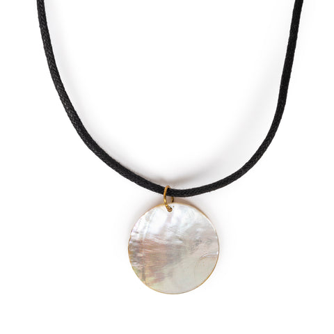 Mother of pearl round pendant necklace hanging, on a solid white background.