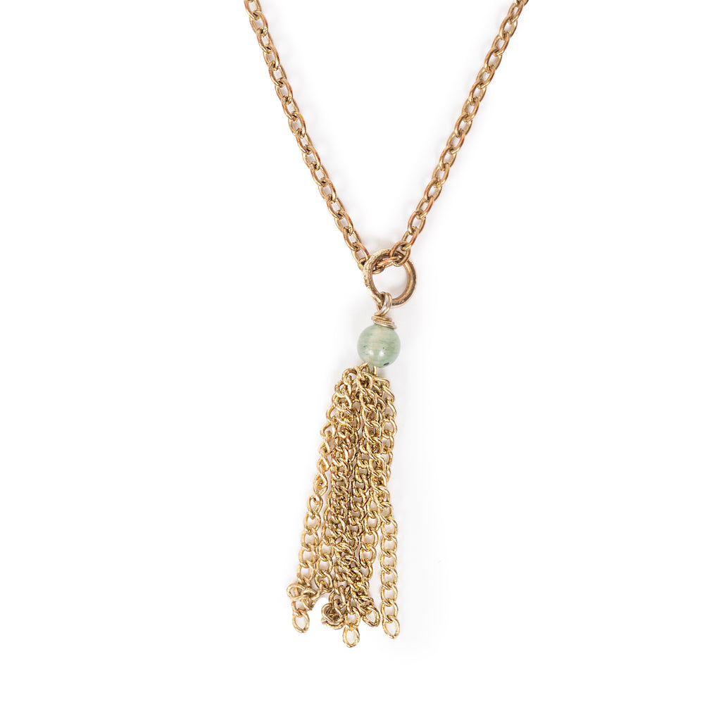 Gemstone charm with gold tone chain dangle, hanging on gold tone chain. Image has solid white background.