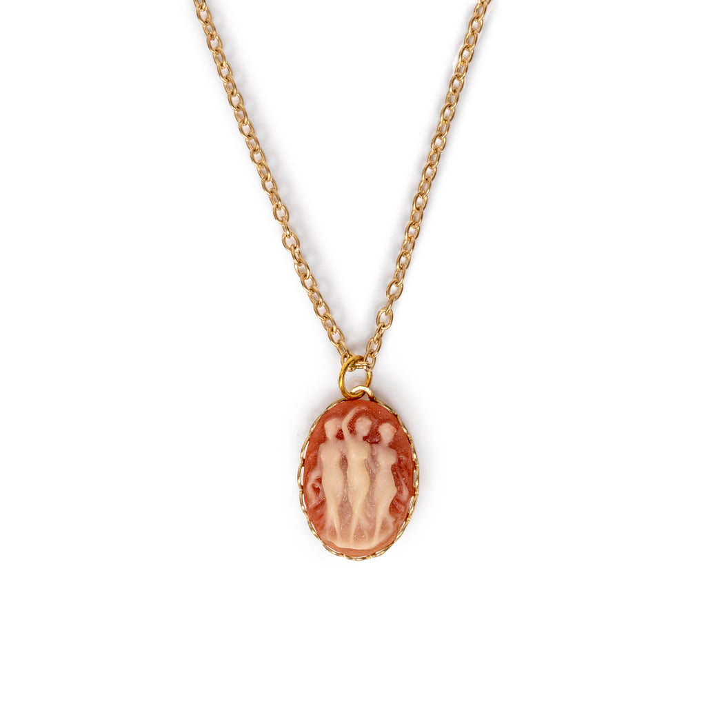 Three dancing ladies in a vintage style, hanging on gold chain, on solid white background.
