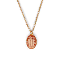 Three dancing ladies in a vintage style, hanging on gold chain, on solid white background.