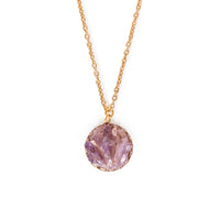 Shards of amethyst in gold backing, hanging on gold chain.