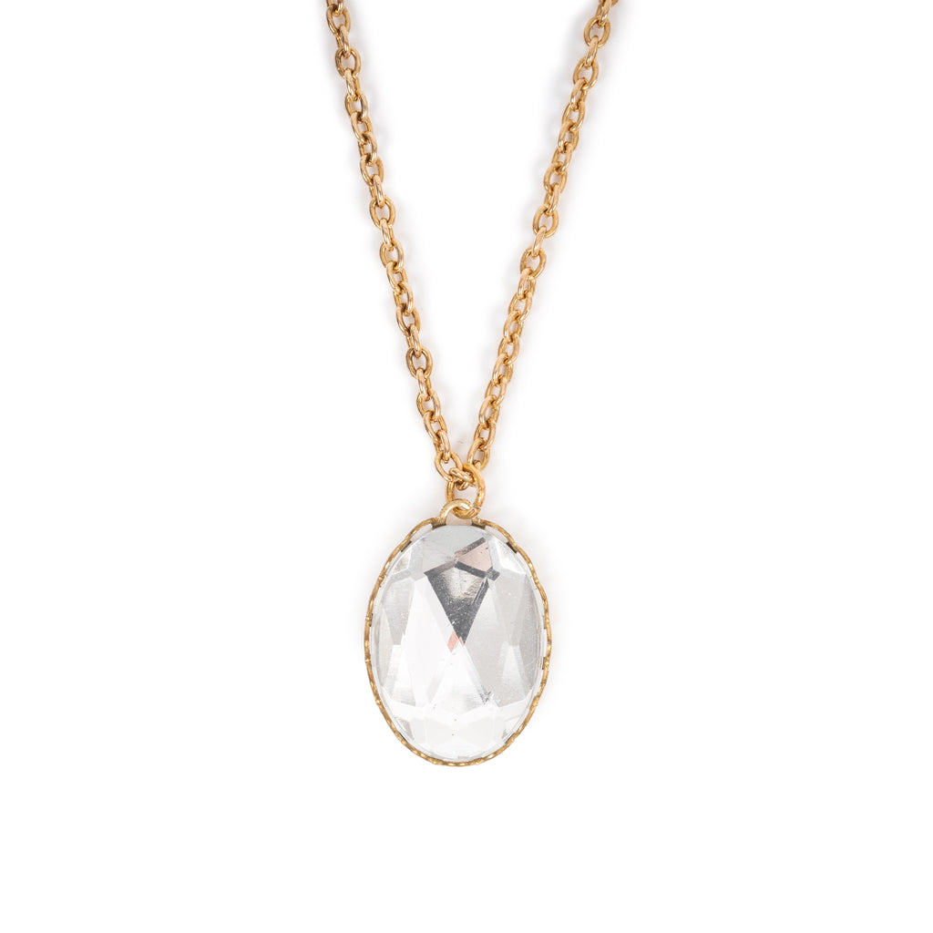 Clear glass cabochon on gold chain. Image is on a solid white background.