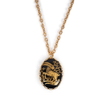 Golden ram cab on gold backing, and hanging on gold chain. Solid white background. 