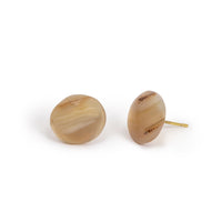 Round agate cab on imitation gold posts. There is banding through the cab, with varying tones. Earrings are sitting on a solid white background.