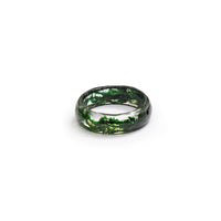 Clear resin ring filled with green dried moss.