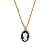 3D Vintage lady cab in black and white, on gold backing, hanging on gold chain. Image has a solid white background.