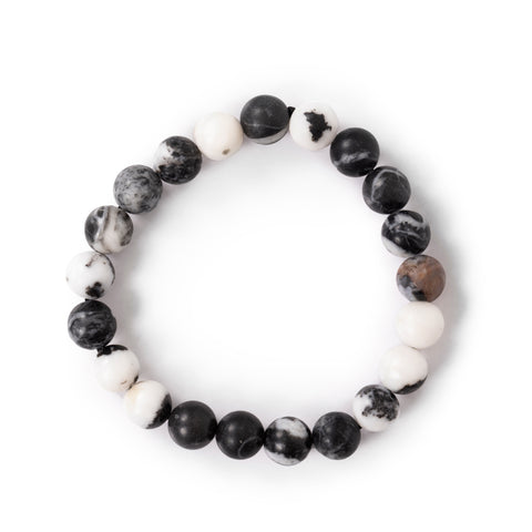 Black, white, and brown agate beaded bracelet laying flat on solid white background.