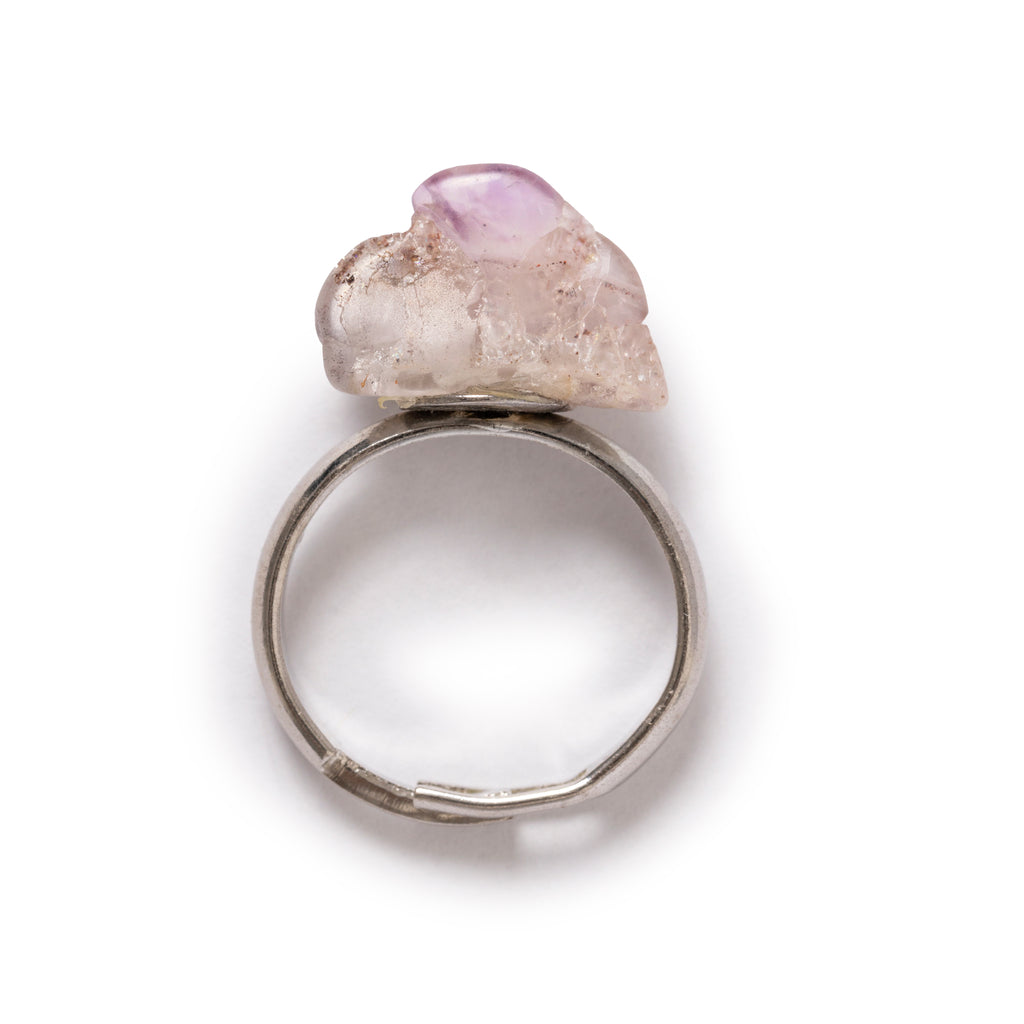 Amethyst ring laying flat on a solid white background. 