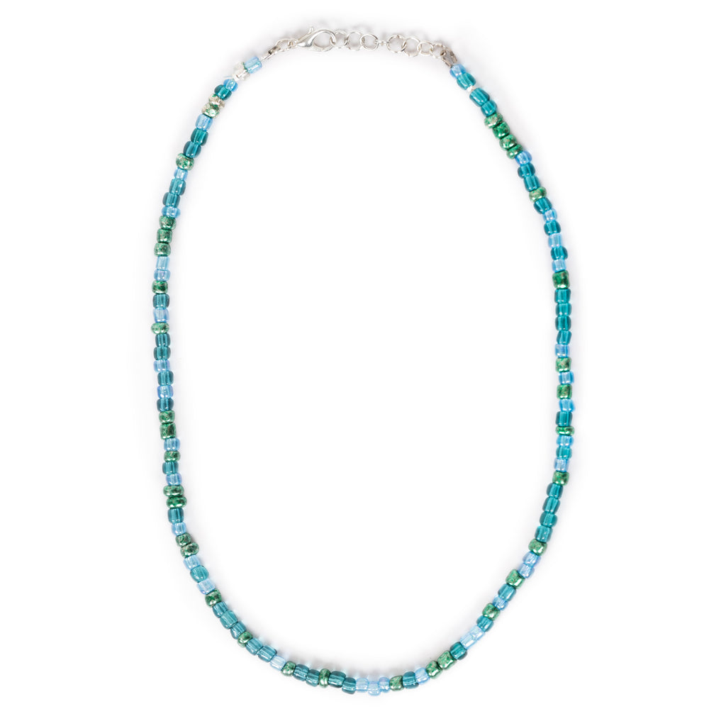 A beaded blue/teal/green necklace laid flat on solid white background. The closure is silver alloy with a lobster clasp. 
