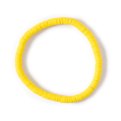Vibrant yellow clay bead anklet seen laying round from above. The background is a solid white. 