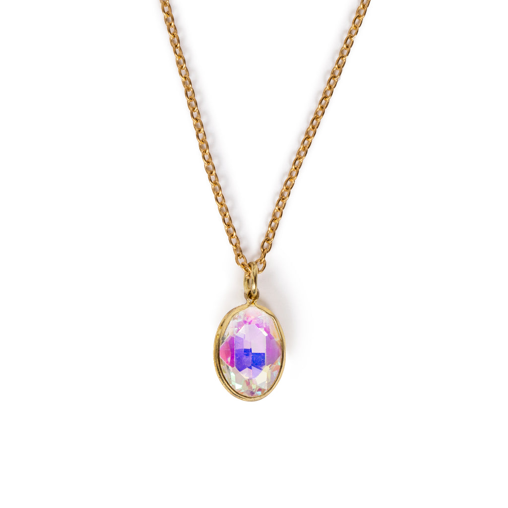Pink opalescent faceted glass charm hanging on gold chain, on solid white background.