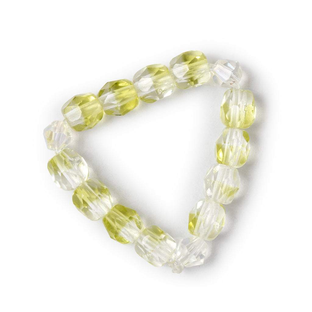 Clear and green mixed beaded ring over head view, on a solid white background.