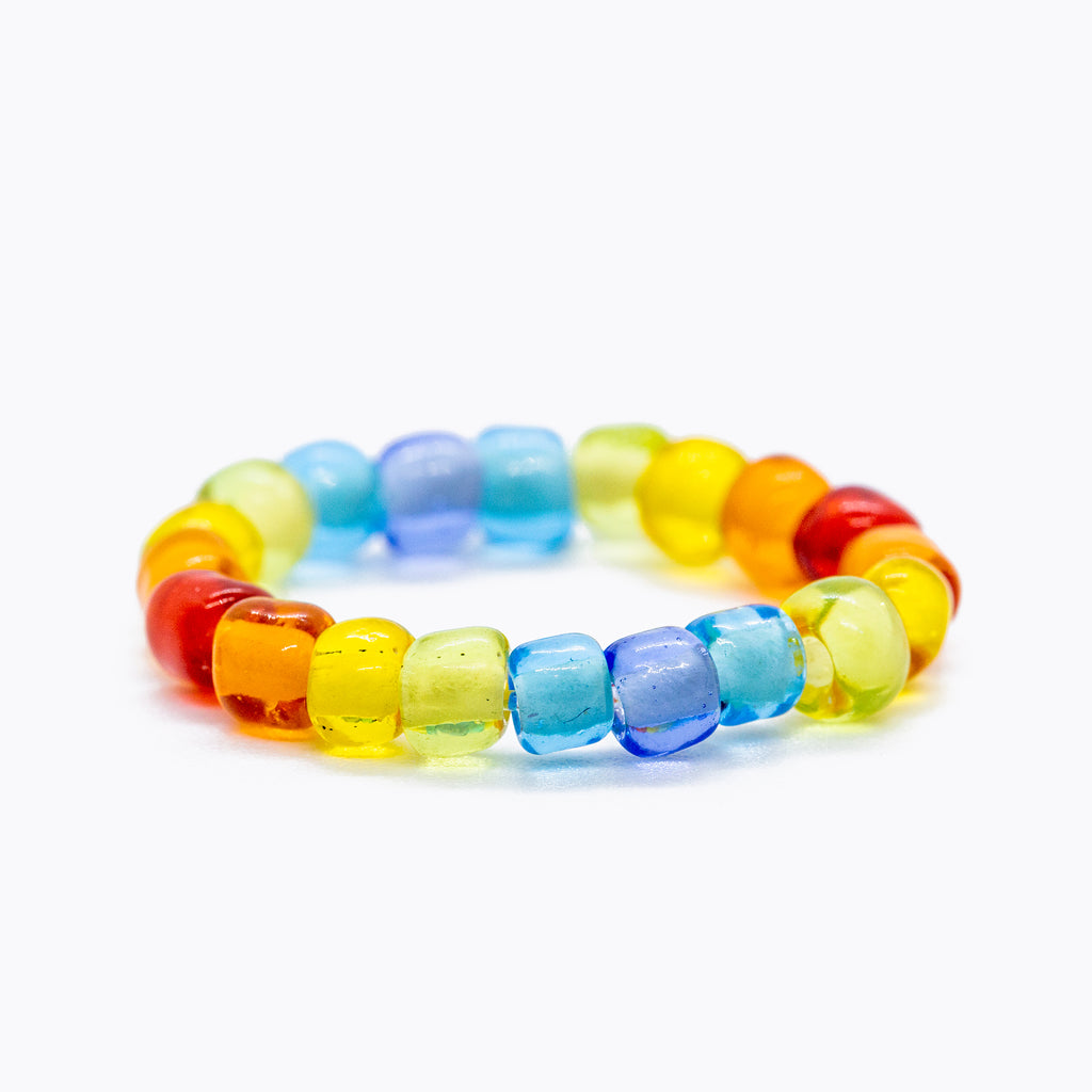 Rainbow beaded ring on solid white background.