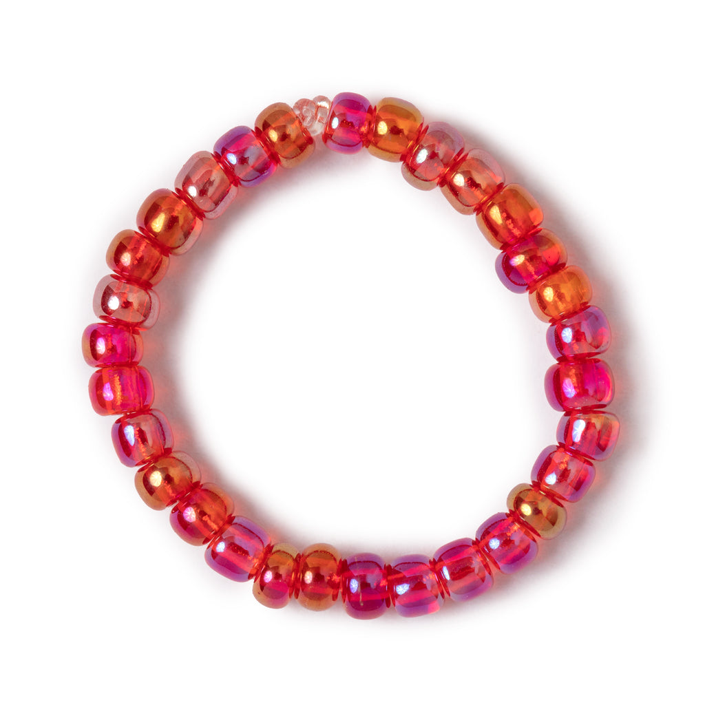 Shades of red beaded ring overhead view on solid white background.