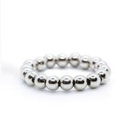 Silver tone beaded ring on solid white background.