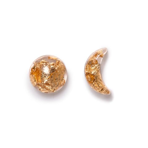 Clear epoxy resin earrings with gold fleck inside. One shaped round like sun, the other in a crescent moon. Solid white background.