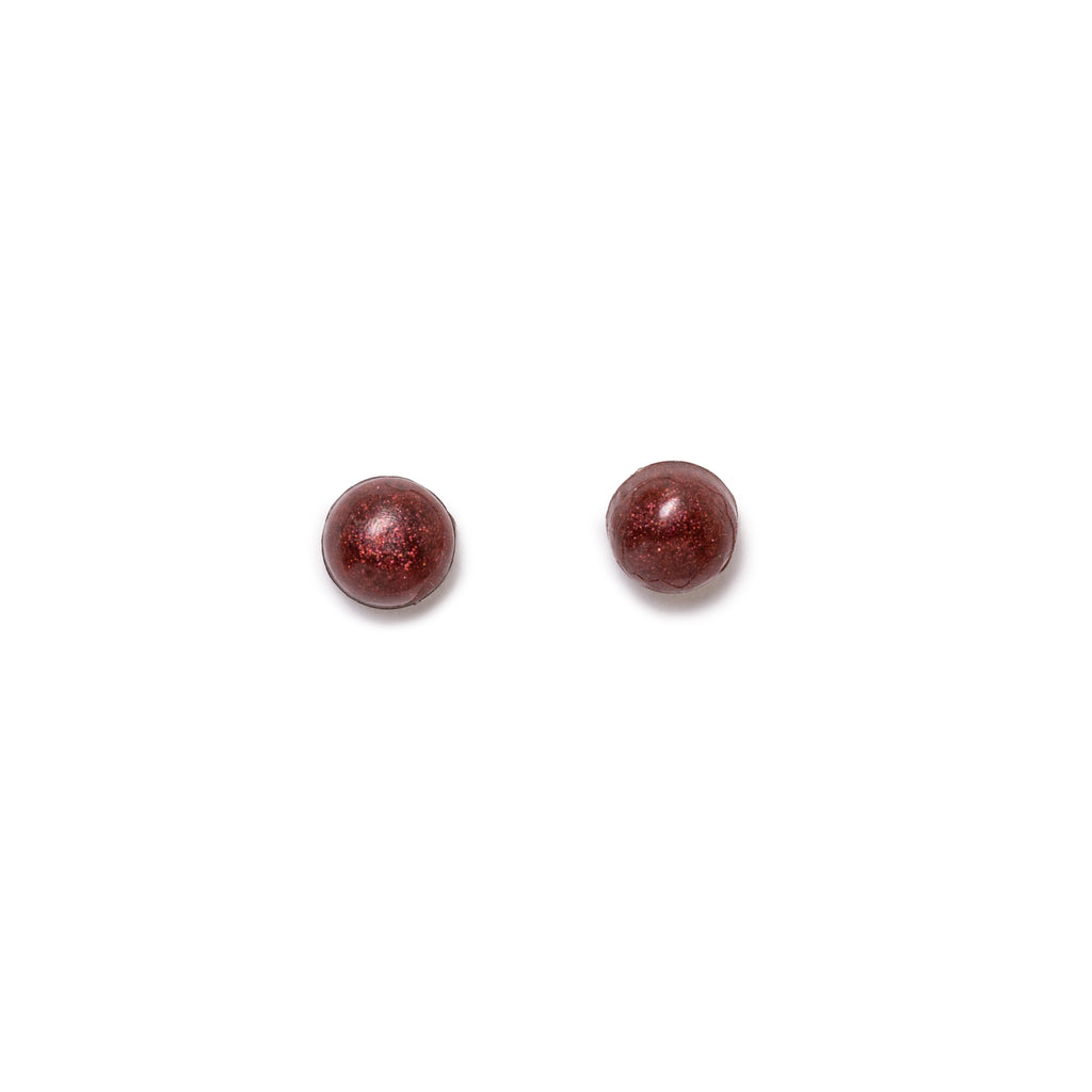 Glittery burgundy round earrings both facing forward, on solid white background.